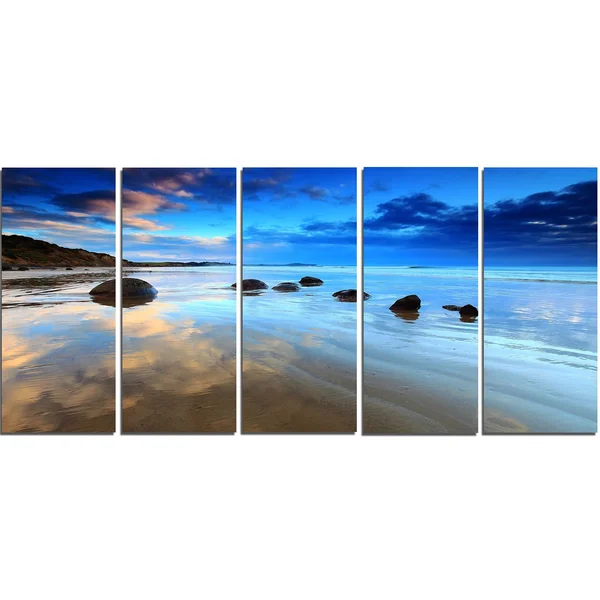 Design Art 'Cloudy Sky Over Moeraki Boulders' Photographic Print on Wrapped Canvas, Size: 16 inch H x 32 inch W x 1 inch D, Blue
